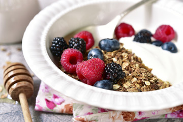 Healthy breakfast : granola, yogurt and fresh berries with honey.