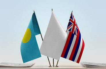 Flags of Palau and Hawaii with a white flag in the middle