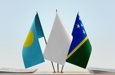 Flags of Palau and Solomon Islands with a white flag in the middle