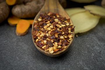 turmeric slices,ginger root and chili pepper on gray background