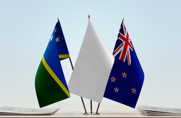 Flags of Solomon Islands and New Zealand with a white flag in the middle