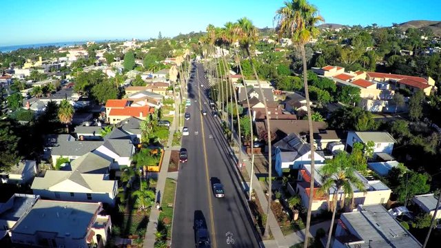 Rising aerial shot over a palm tree lined street in Southern California.