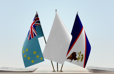 Flags of Tuvalu and American Samoa with a white flag in the middle