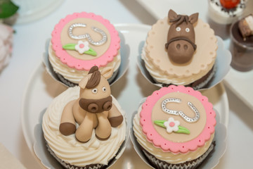 Colorful festive cupcakes on table