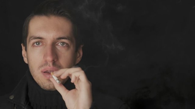 Portrait of man smokes a cigarette and coughs. Diseases from bad habits