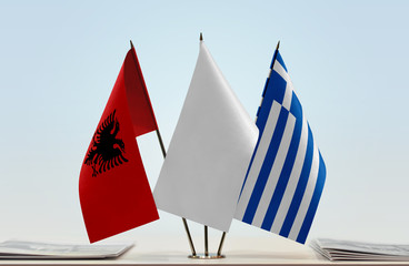 Flags of Albania and Greece with a white flag in the middle