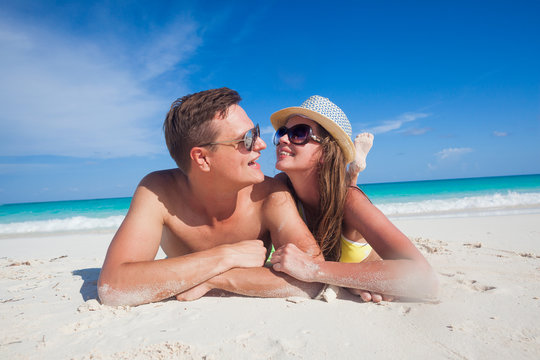 attractive couple enjoying sunny day at Cayo Largo beach, Cuba