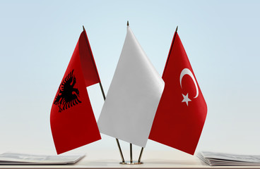 Flags of Albania and Turkey with a white flag in the middle
