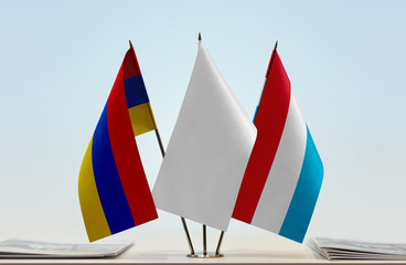 Flags of Armenia and Luxembourg with a white flag in the middle