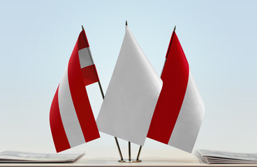 Flags of Austria and Monaco with a white flag in the middle