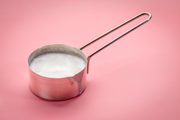 coconut cooking oil  in a measuring scoop