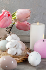 Eggs and aroma candles on old wooden background