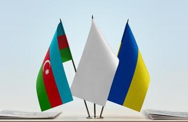 Flags of Azerbaijan and Ukraine with a white flag in the middle