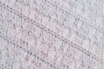 Textile background  in vintage style -- flannel, cotton into the classic cell and vintage homemade knitted lace of crochet napkins in retro style, double exposure photo.