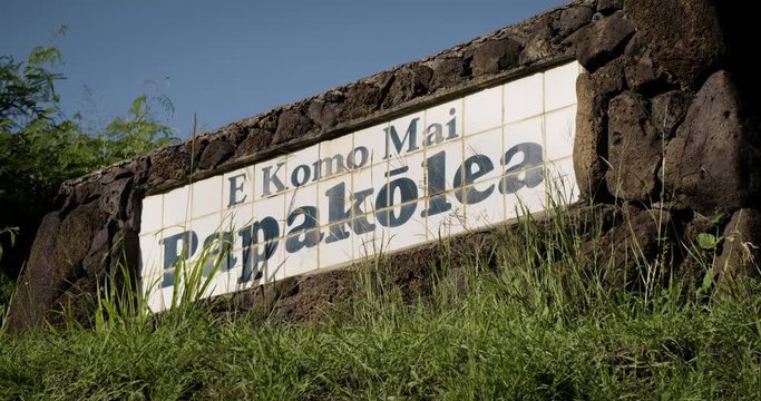 A sign in a Hawaiian neighborhood urges people to slow down and respect safety.