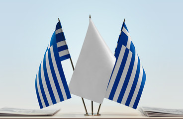 Two flags of Greece with a white flag in the middle
