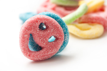 closeup of acidulous smiley candies on white background