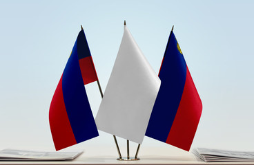 Two flags of Liechtenstein with a white flag in the middle