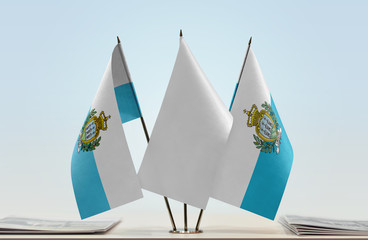 Two flags of San Marino with a white flag in the middle