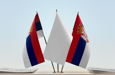 Two flags of Serbia with a white flag in the middle
