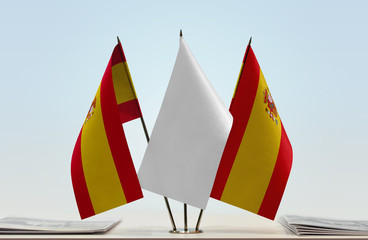 Two flags of Spain with a white flag in the middle