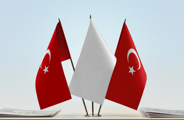 Two flags of Turkey with a white flag in the middle