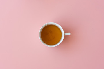 Directly above view of tea in cup on pink background