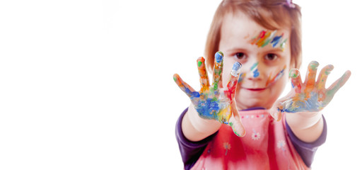 Fototapeta na wymiar Colorful painted hands in a beautiful young girl (art, childhood, color)