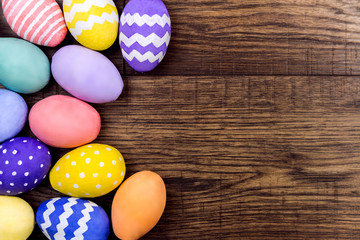 Happy Easter concept. Colorful easter eggs on wooden background