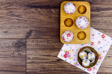 Happy Easter concept. Wooden stand for eggs in shape of heart, easter eggs with spring's flower pattern