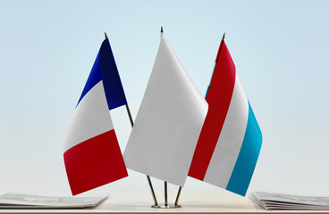 Flags of France and Luxembourg with a white flag in the middle