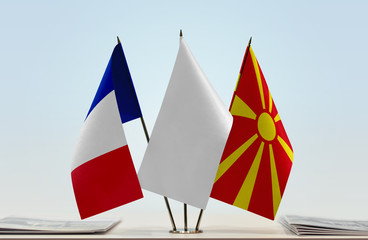 Flags of France and Macedonia with a white flag in the middle