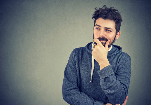 Young hipster man in deep thoughts