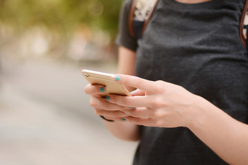 Close up of woman's hands texting with smartphone