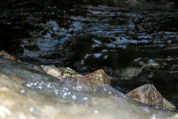 Mountain stream is washed by sharp rocks of the mountain