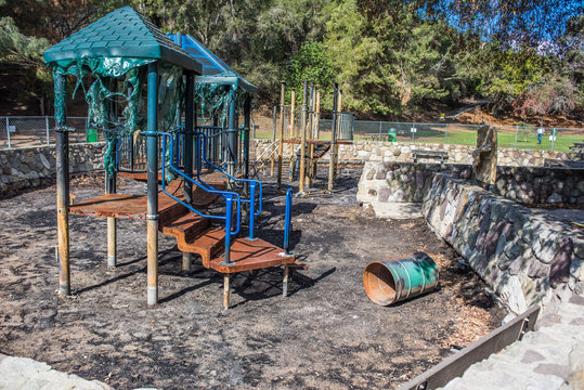 Burnt playground equipment is melted and full of charred ash after the wildfire spread through Ventura.