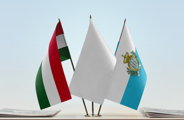 Flags of Hungary and San Marino with a white flag in the middle