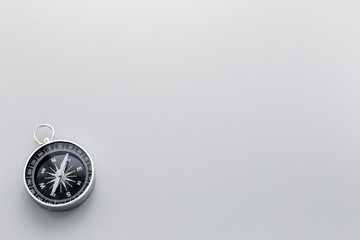 Compass on gray background top view copy space