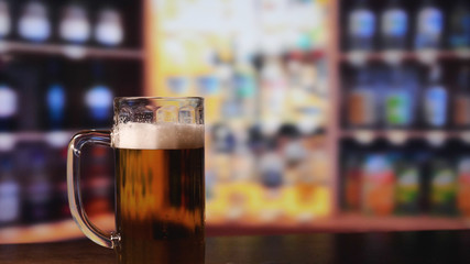 A glass of beer is on the bar.