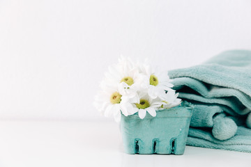 Obraz na płótnie Canvas Spring flowers and turquoise blanket. Minimal concept
