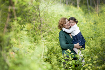 Grandmother hugging her granddaughter in the park
