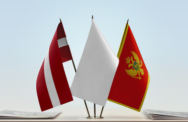 Flags of Latvia and Montenegro with a white flag in the middle