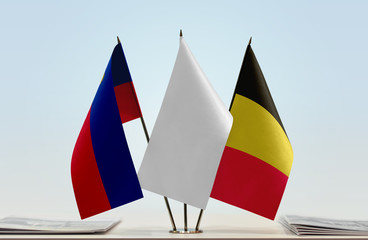 Flags of Liechtenstein and Belgium with a white flag in the middle