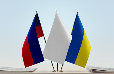 Flags of Liechtenstein and Ukraine with a white flag in the middle