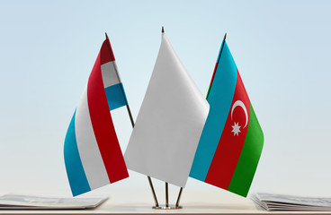 Flags of Luxembourg and Azerbaijan with a white flag in the middle