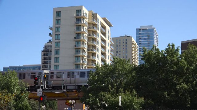 Establishing shot of a neighborhood in downtown Chicago wil El train passing.
