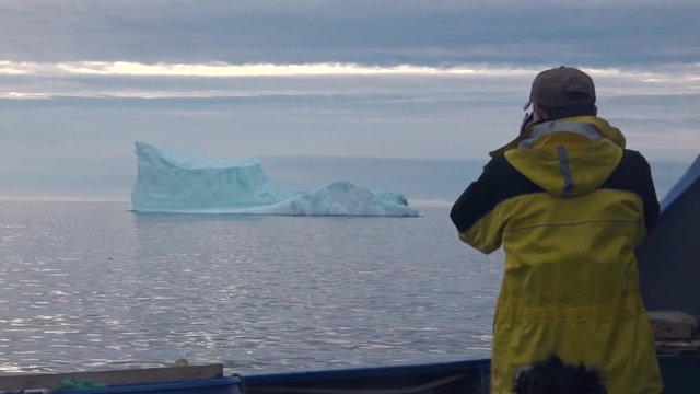 Researchers observe and photograph icebergs in the Arctic.
