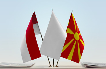 Flags of Monaco and Macedonia with a white flag in the middle