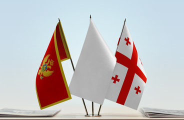 Flags of Montenegro and Georgia with a white flag in the middle