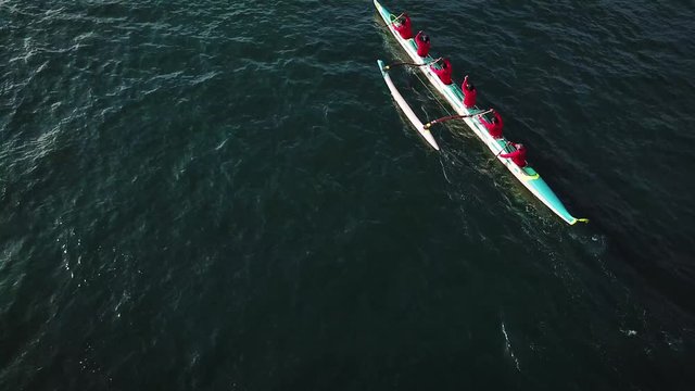 Beautiful aerial over many outrigger canoes at the start of a race in Hawaii.